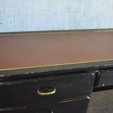 Hungarian Art Deco desk in black painted wood with a brown top and metal handles.