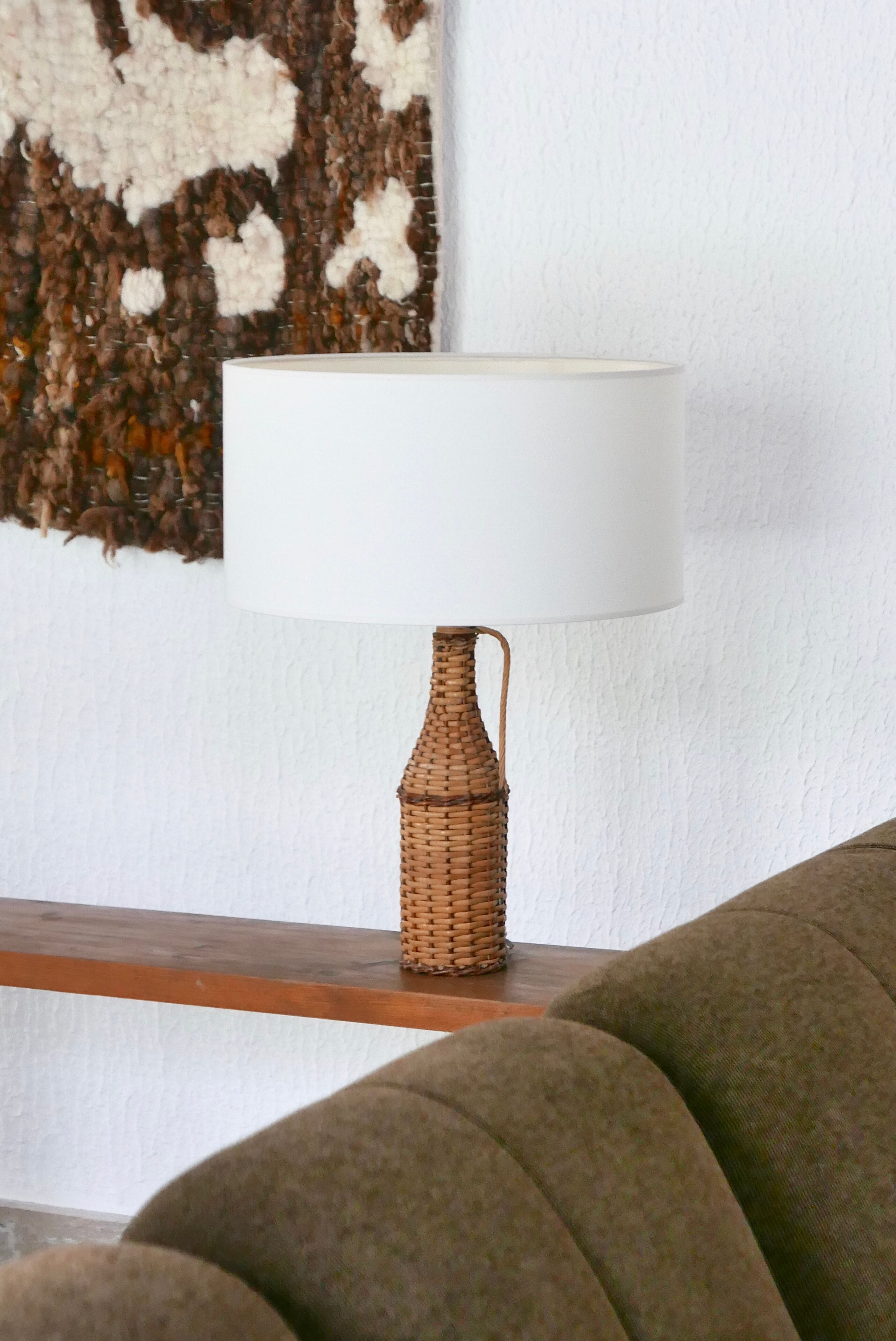 bottle lamp covered with wicker, white drum lampshade, 70s