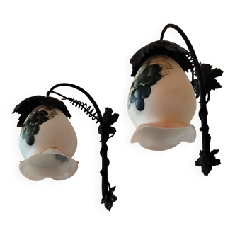 Pair of black wrought iron wall lights and glass tulips with vine leaf decoration