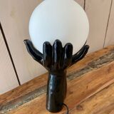 Lamp hands holding a globe