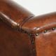 Sheepskin wingback armchair finished with black piping and a correct seat
