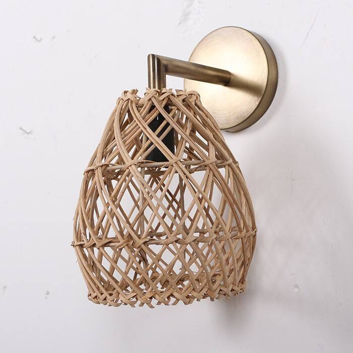 Golden bohemian wall lamp in woven rattan