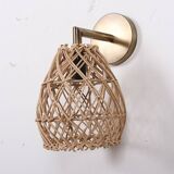 Golden bohemian wall lamp in woven rattan