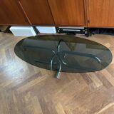 70s design oval coffee table in smoked black glass with chrome legs.