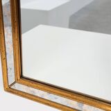 Mirror by Deknudt with marbled fume glass side panels in gilded wooden fram