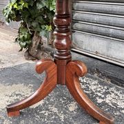 19th-century solid mahogany table with a tilting top and brass mechanism.