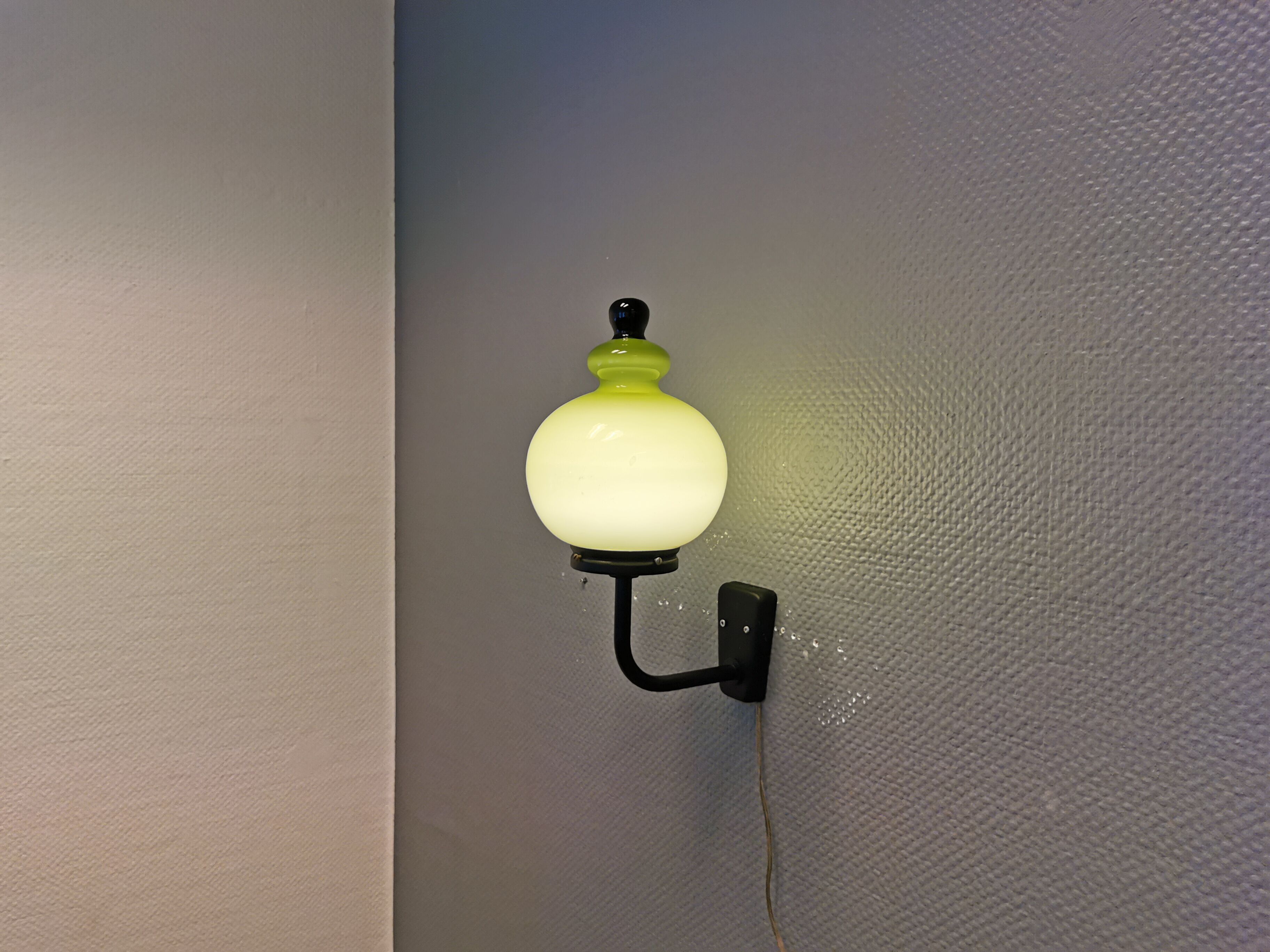 Wall light, made in black metal frame with olive green glass shade