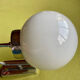 Pair of chrome metal wall lights with white glass globe.