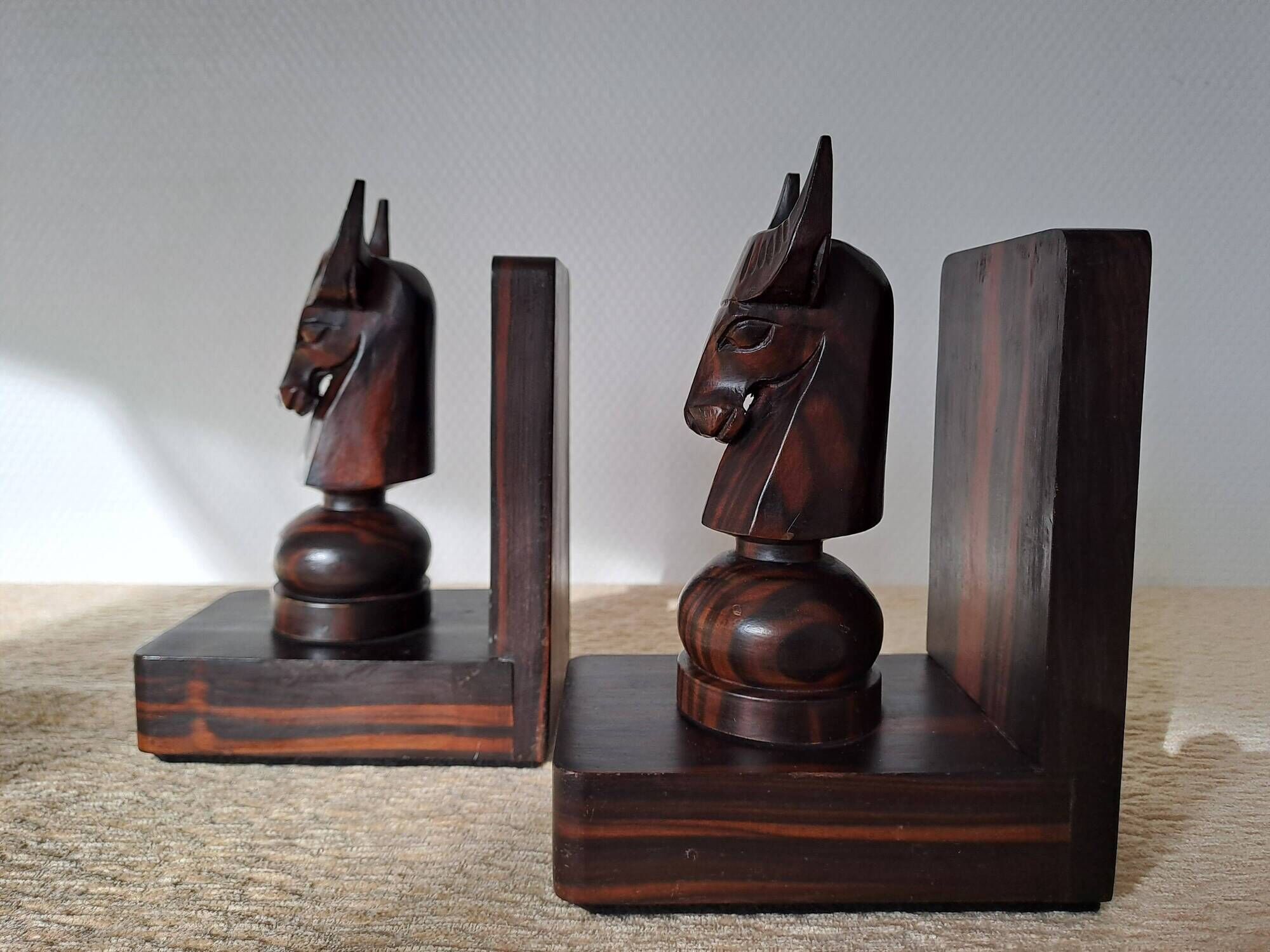 Pair of vintage wooden bookends with stylised horse heads.