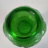 Green glass vase decorated with bunch of grapes and fruits