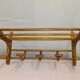 Coat rack with curved wooden hat holder