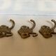 Three double brass coat hooks.