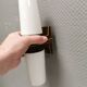 Old bathroom lamp with brown/golden ceramic base, porcelain socket and milky white glass