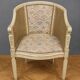 Gondola armchair in Louis XVI style, carved wood with a cream patina.