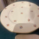 Dessert plate and porcelain dishes with a multicoloured floral pattern, vintage.