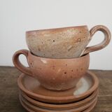Stoneware cups with saucers