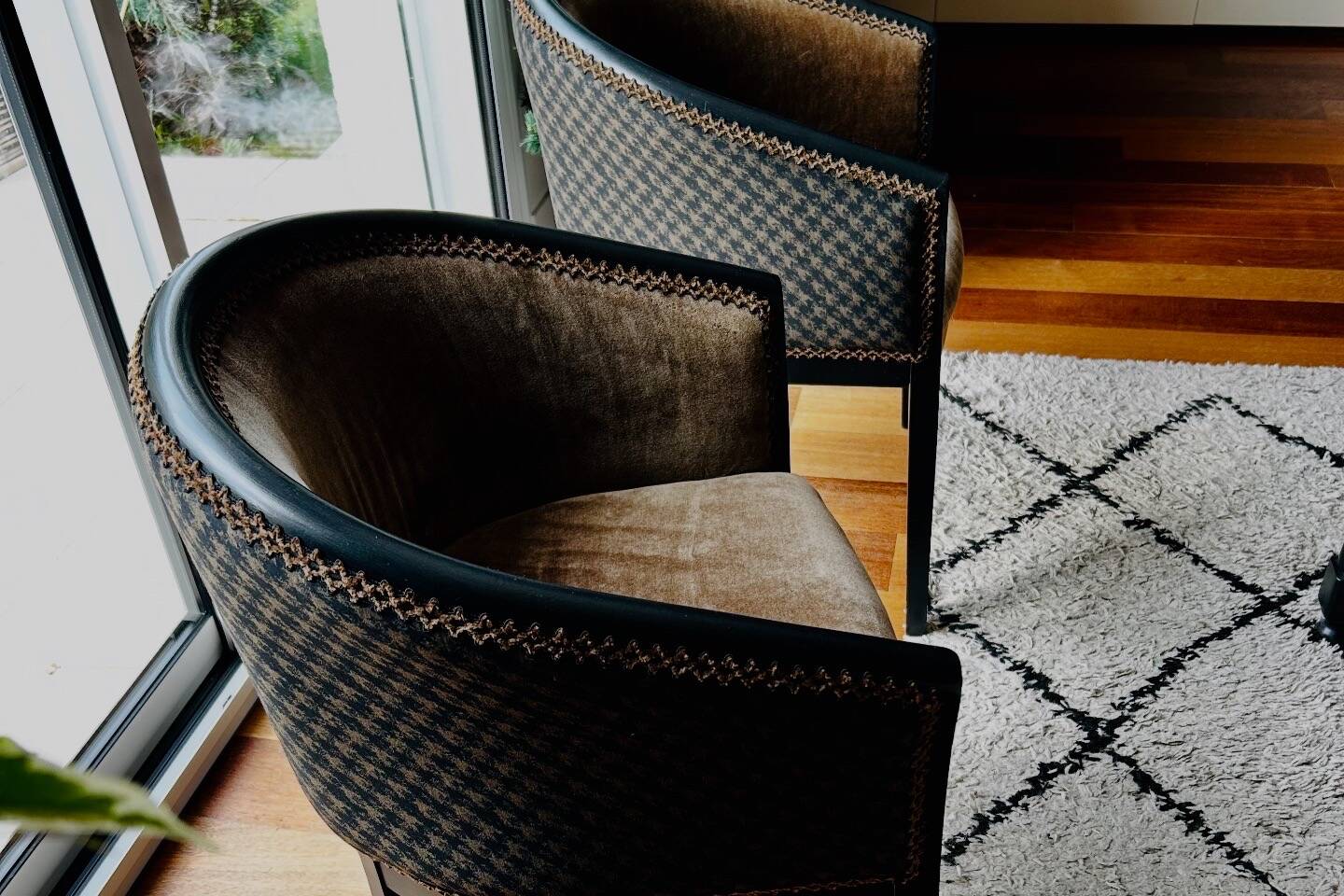 Pair of Art Deco barrel chairs in black and bronze