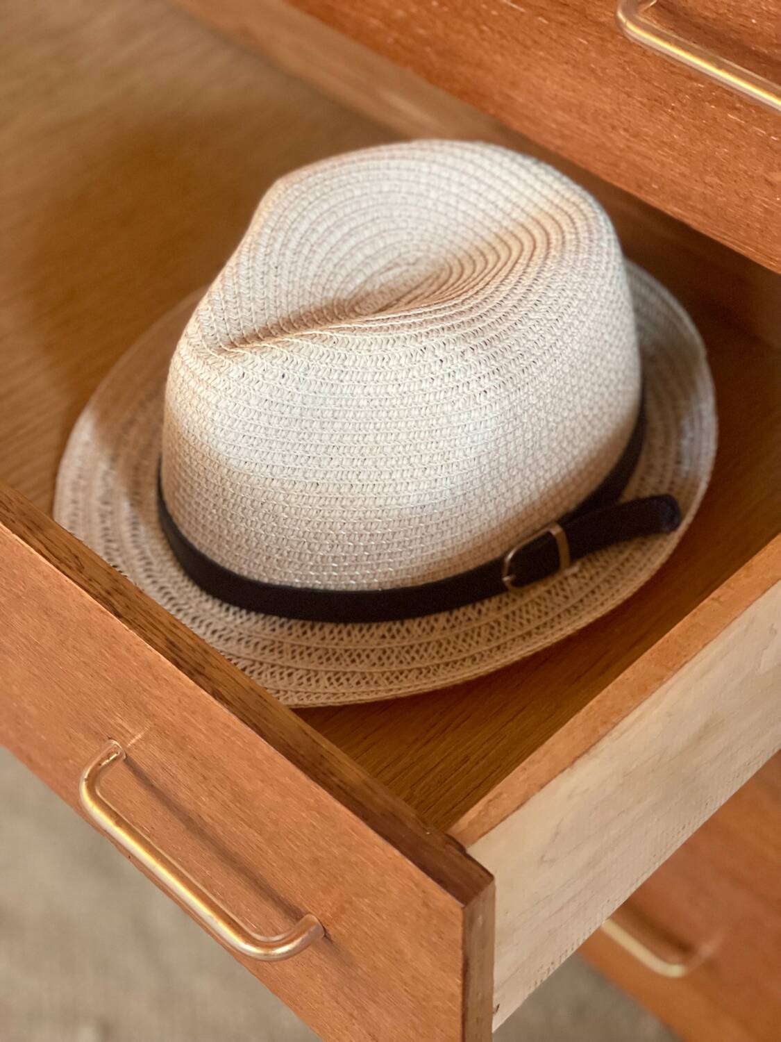 Vintage 1960s chest of drawers with covered handles.