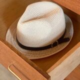 Vintage 1960s chest of drawers with covered handles.