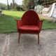 Red fabric armchair in Mid-Century Scandinavian style, high back and light wood legs (1960s)
