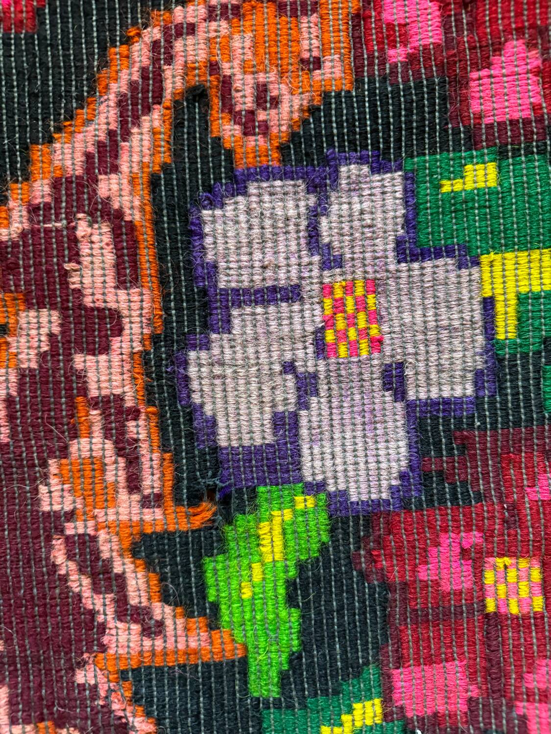 Bohemian floral design, handwoven wool rug, black background with colorful flowers