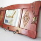 Red wooden wall-mounted coat rack and Art Deco mirror