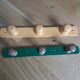 Wall-mounted coat rack with 3 mushroom-shaped hooks