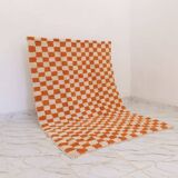 Orange checkered rug made entirely by hand