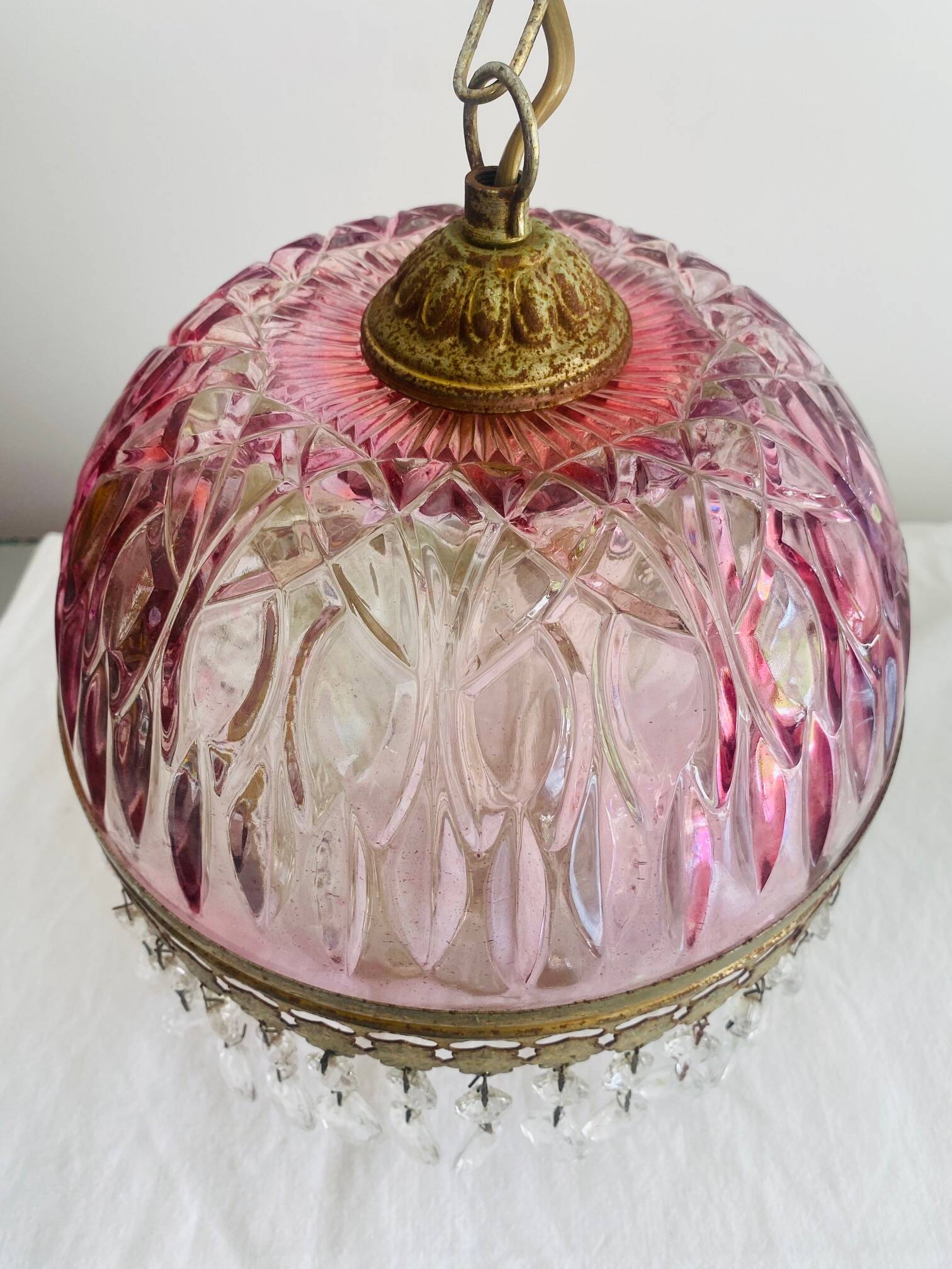Antique pink glass pendant light with tassels.
