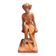 Painted plaster sculpture of a nude woman on a bench