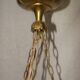 circular chandelier with a brass frame and crystal drops