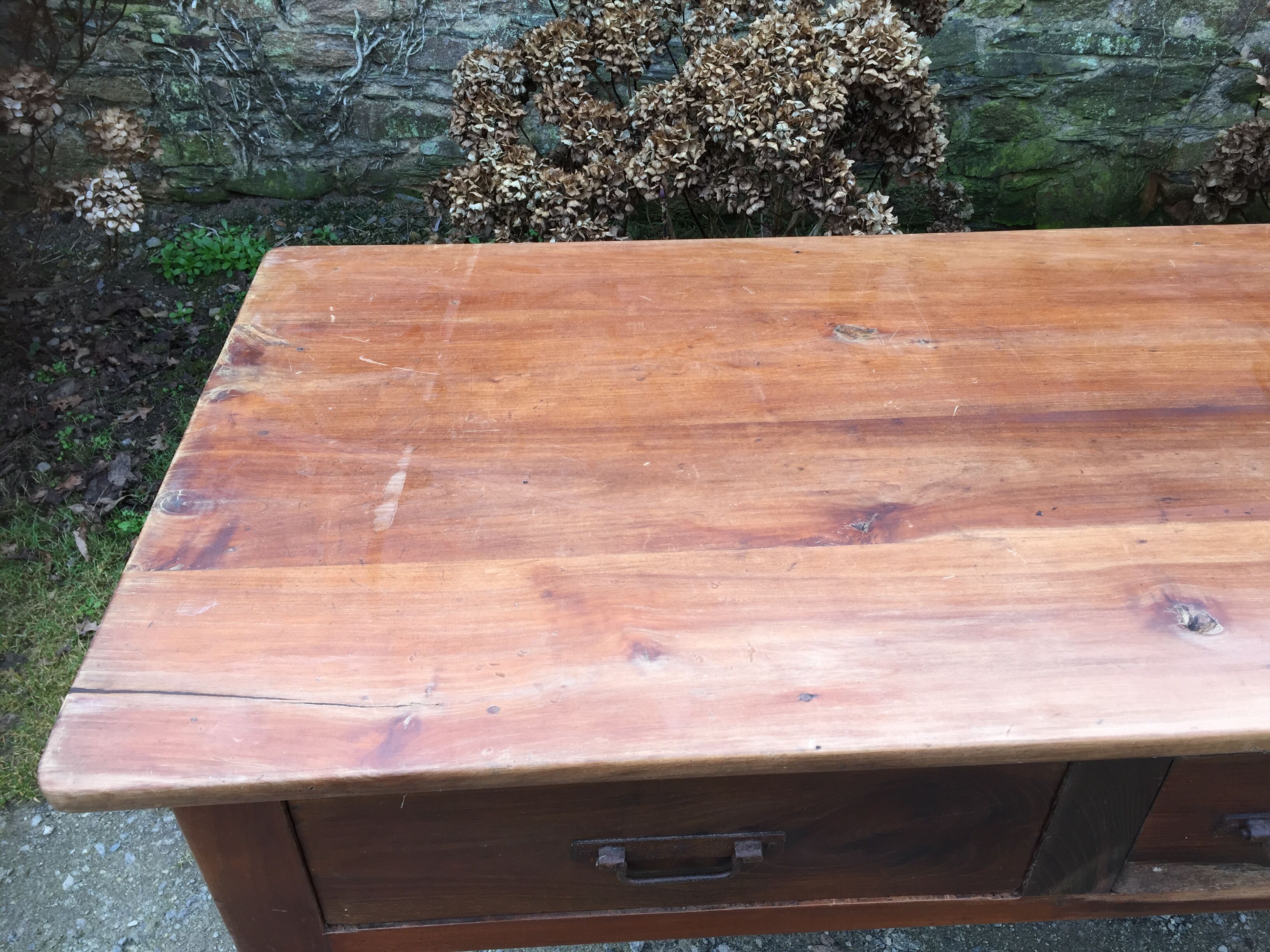 Old farmhouse table with cherry and chestnut panels with 3 drawers.