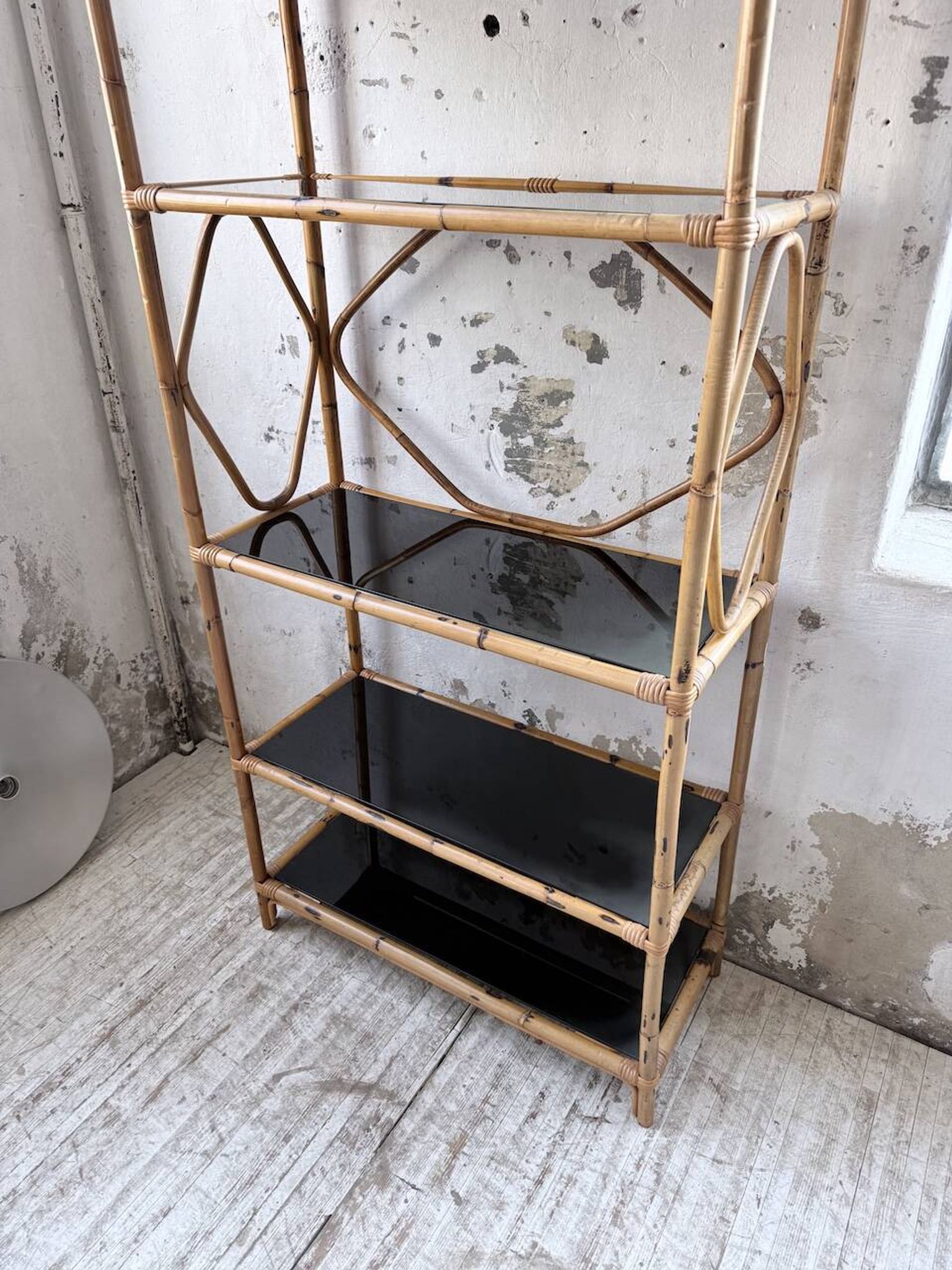 Rattan bookshelf and black glasses