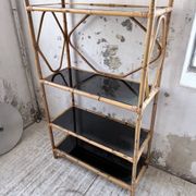 Rattan bookshelf and black glasses