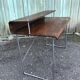 Design desk in formed glued laminated wood with chrome tubular base.