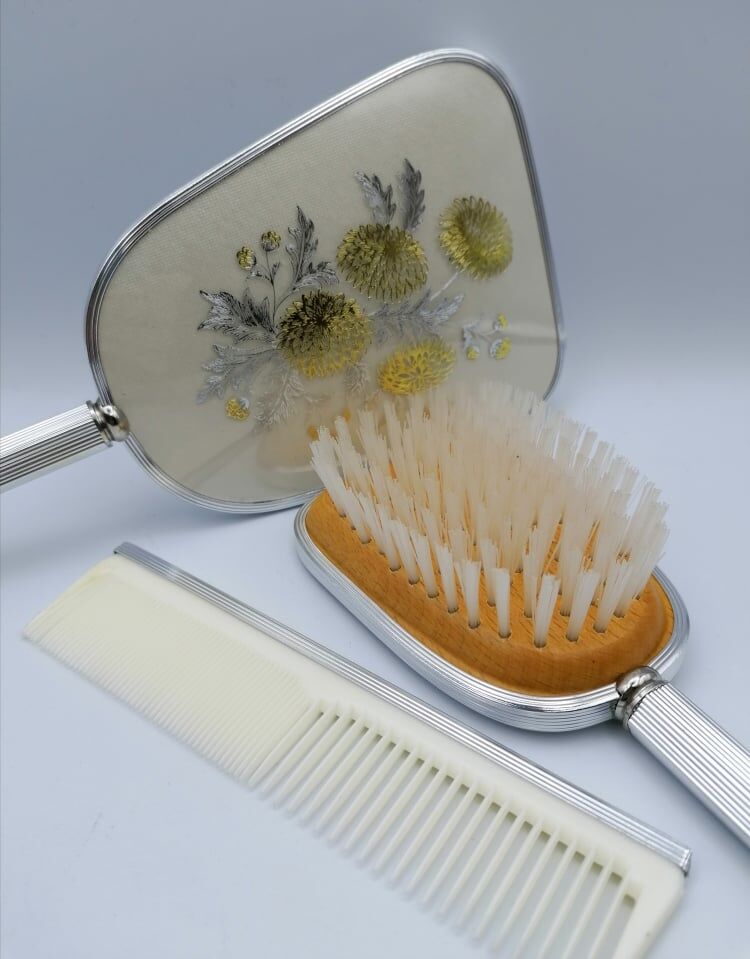 Hand mirror assembly, comb and brush.