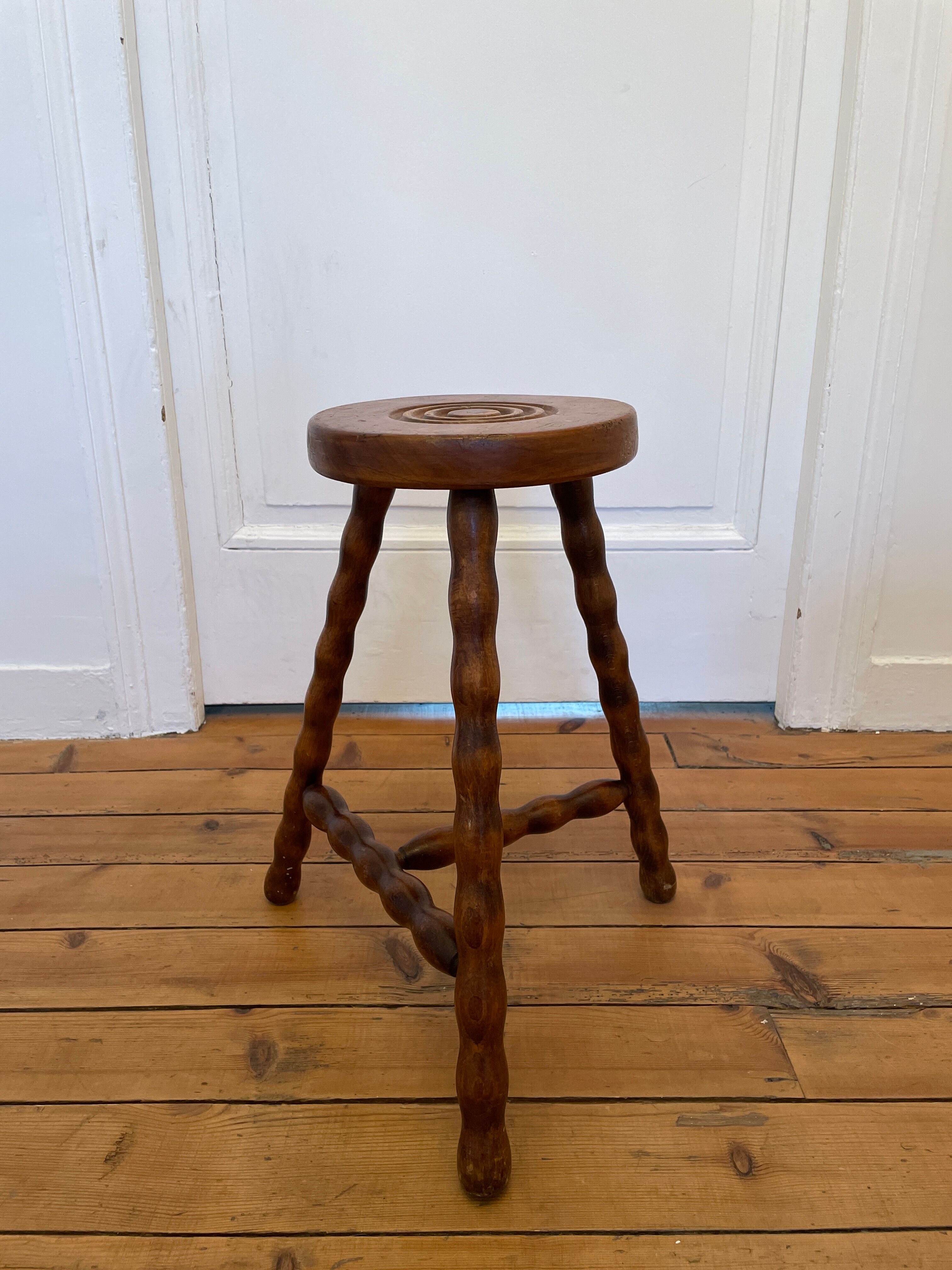 Old wooden tripod stool
