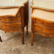 Pair of bow-fronted chests of drawers in walnut