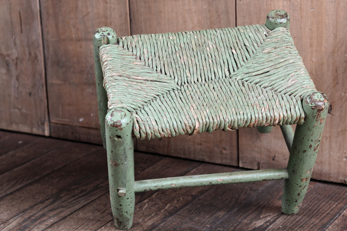 Old wooden and straw stool