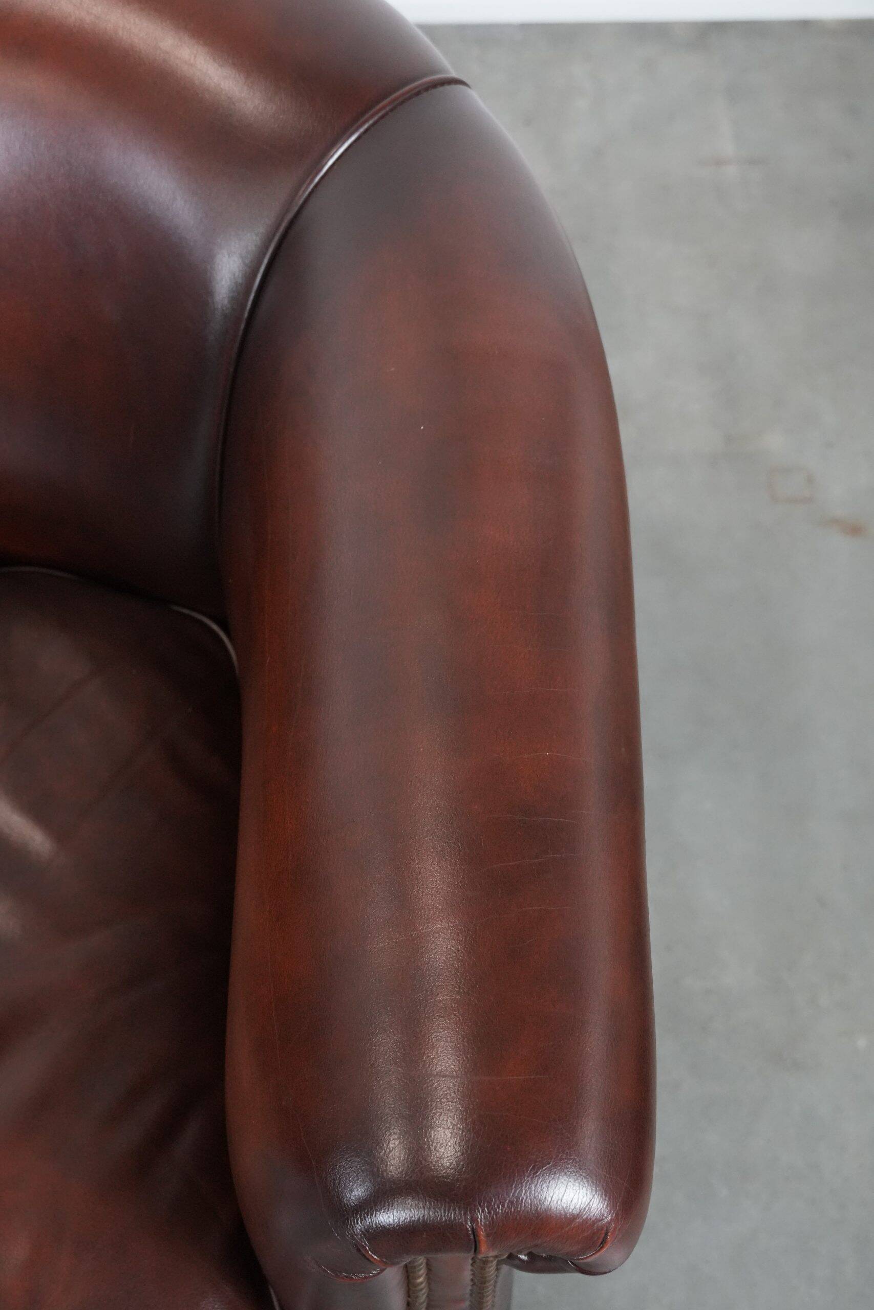 Set of two cow leather club armchairs in a luxurious red/brown colour