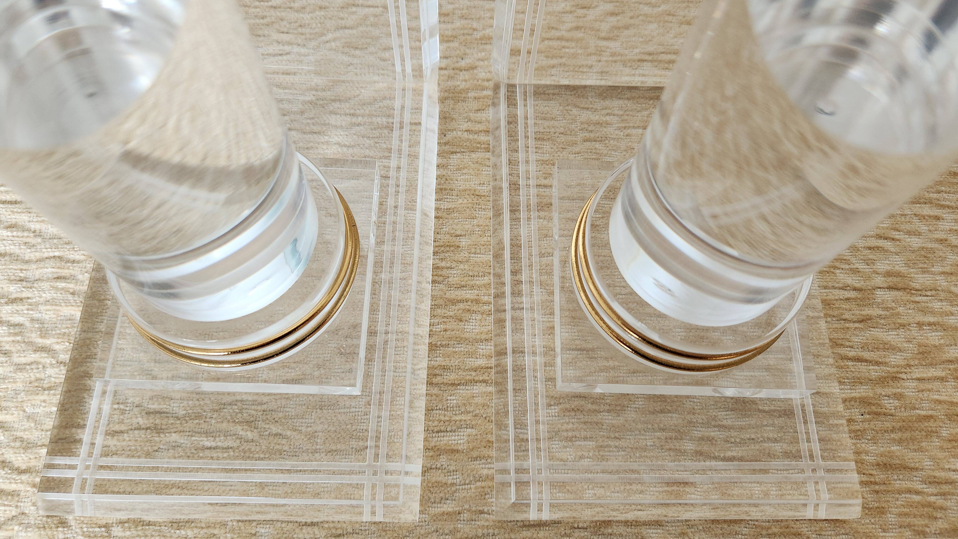 Pair of column bookends in plexiglass and gold metal, 1980s design.