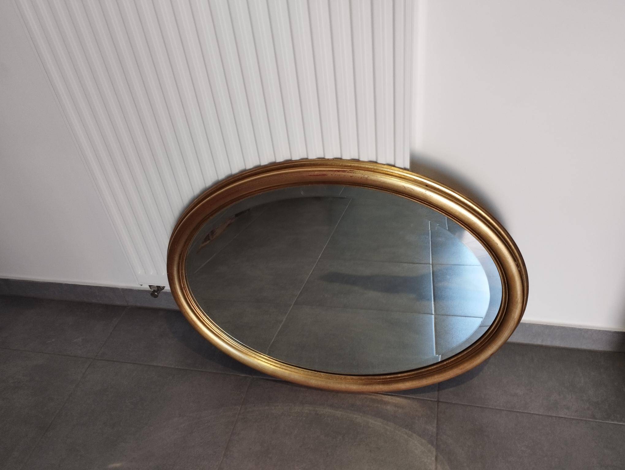 Grand et élégant miroir doré ovale avec sa glace biseauté