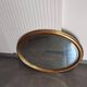 Grand et élégant miroir doré ovale avec sa glace biseauté