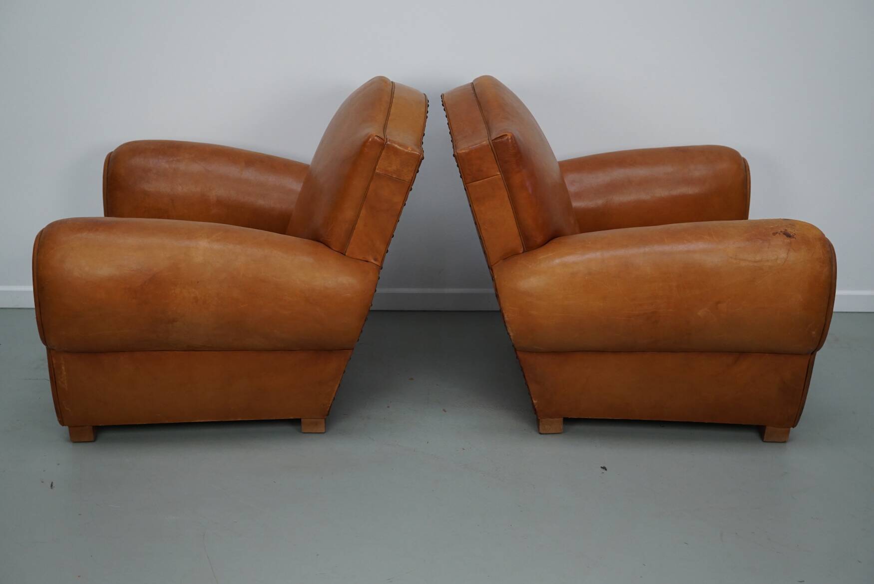Pair of French club chairs with moustache back in cognac leather, 1950s