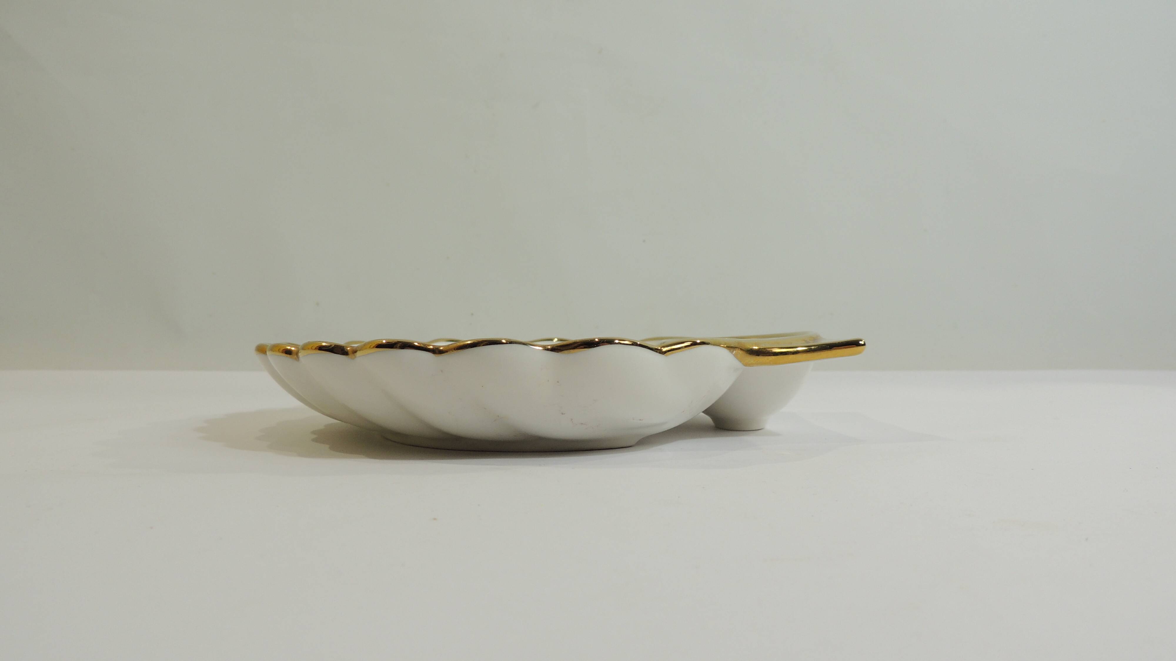 Shell-shaped porcelain pocket bowl from Queen’s Porcelain, with a gold rim.