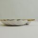 Shell-shaped porcelain pocket bowl from Queen’s Porcelain, with a gold rim.