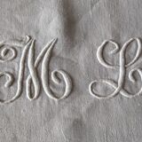 12 large antique damask towels with floral decoration and embroidered with the ML monogram