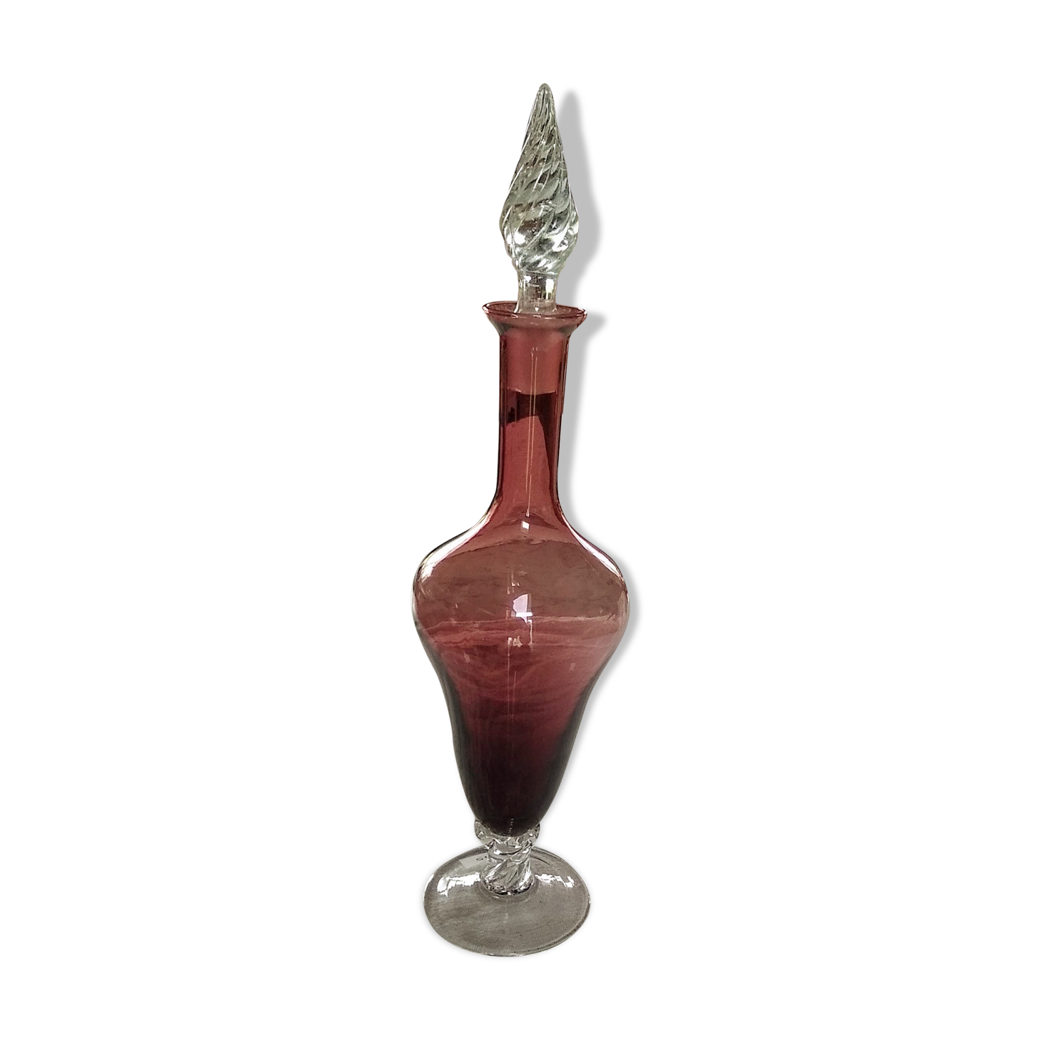 Purple-colored liquor-blown glass decanter with carved foot