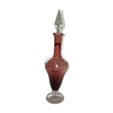 Purple-colored liquor-blown glass decanter with carved foot