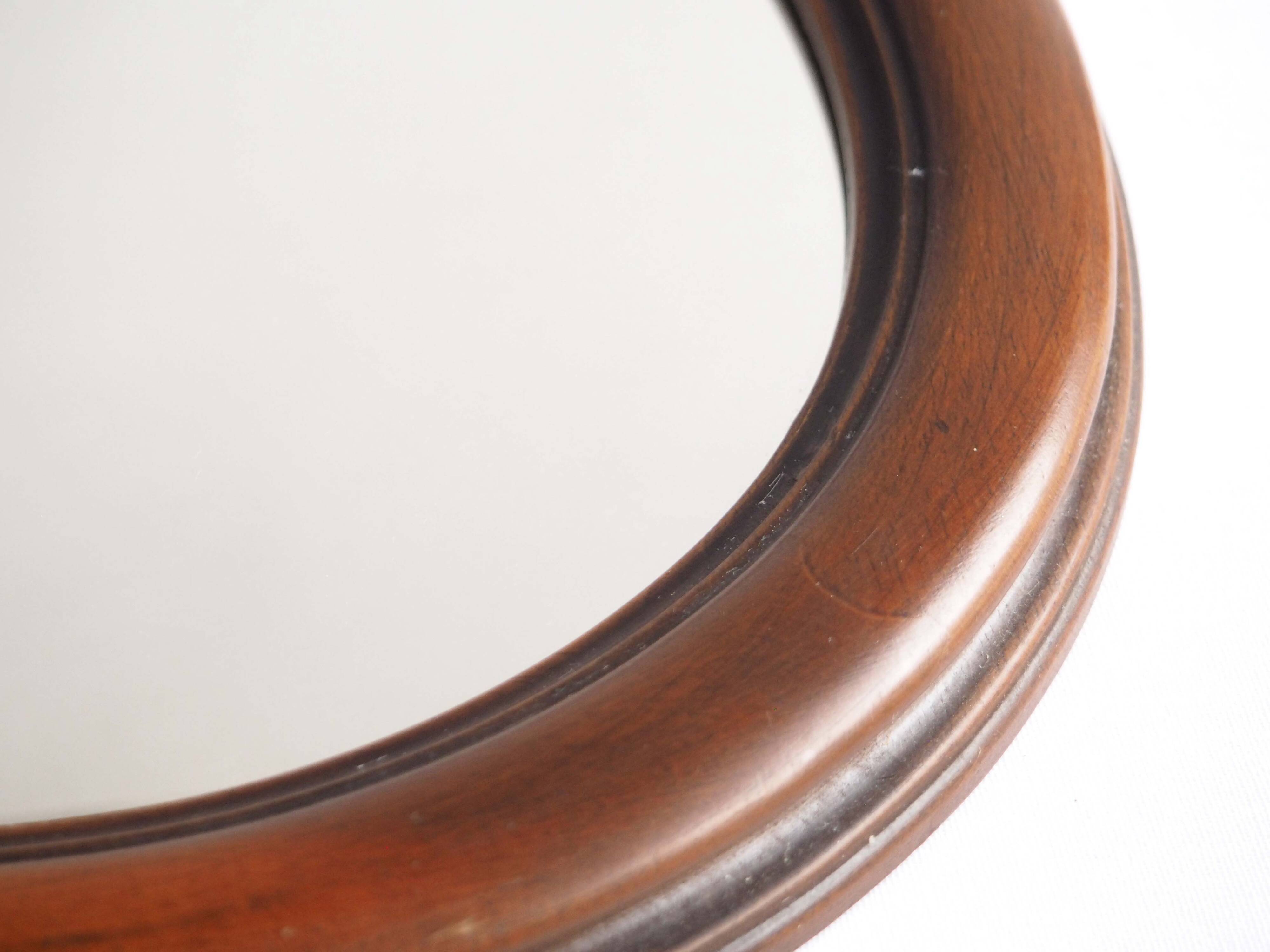Oval mirror with wooden frame